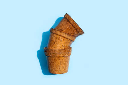 Coco coir pots on blue background.