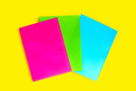 Office folders on yellow background. Top viewの写真素材