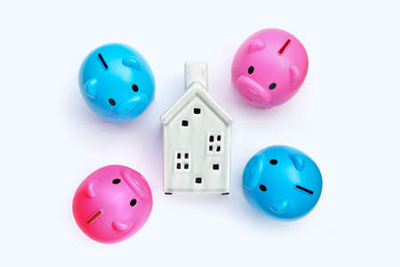 Piggy bank with ceramic house on white background.の写真素材