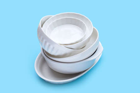 Stack of dishes bowl on blue background.