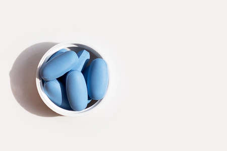 PrEP ( Pre-Exposure Prophylaxis) used to prevent HIV with wooden clock and glass of water on whiteの写真素材