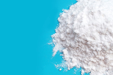 Baking soda on blue background.
