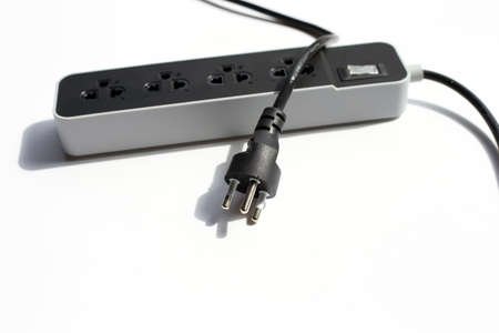 Electrical power strip and plug on white background.の写真素材