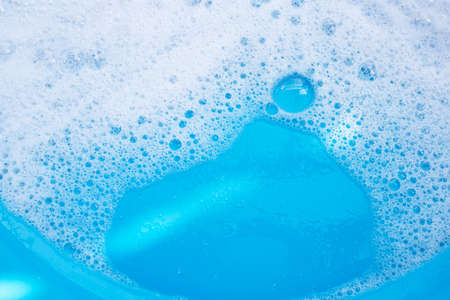Detergent foam bubble, blue background.の写真素材