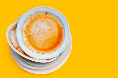 Dirty dishes on yellow background.の写真素材