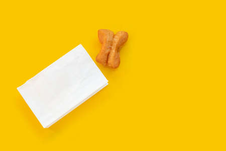 Deep-fried dough sticks or chinese bread stick on yellow background.の写真素材