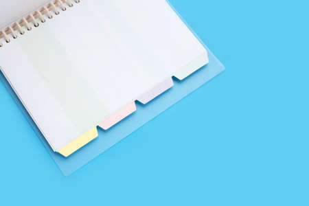 Open notebook on blue backgroundの写真素材