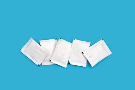 Sugar sachets on blue background.の写真素材