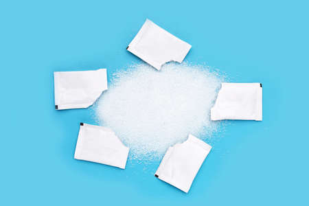 Sugar sachets on blue background.の写真素材