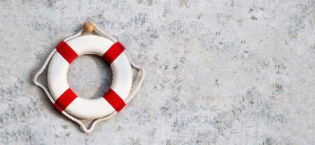 Lifebuoy on cement wall background. Copy spaceの写真素材
