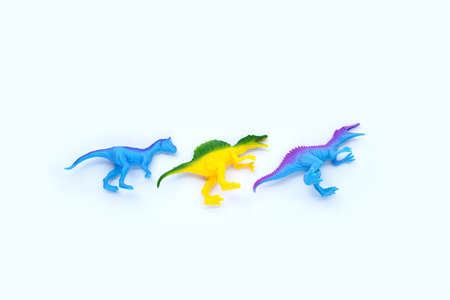 Plastic dinosaur toys on white background. Top view