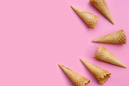 Empty ice cream cone on pink background.の写真素材
