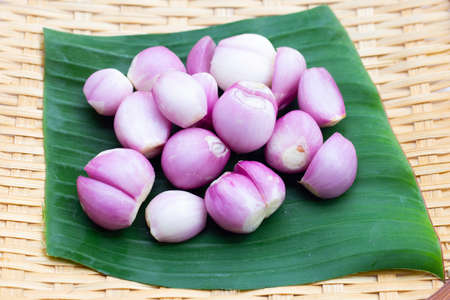 Fresh shallot on bamboo plateの写真素材