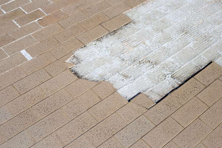 Cracked brown tiles on cement floor