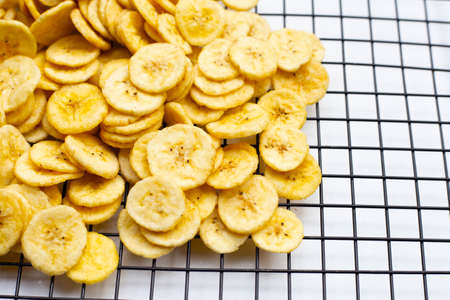 Banana slice chips on white background.の写真素材