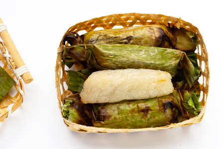 Grilled sticky rice in banana leaves with banana fillingの写真素材