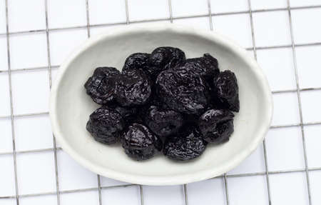 Dried prunes on white backgroundの写真素材