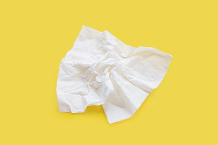 Facial tissue on yellow background.