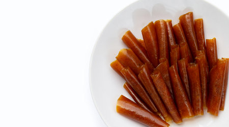 Dried mango paste sheets on white background.の写真素材