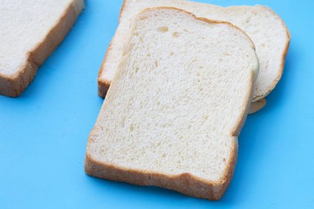 Sliced bread on blue background.の写真素材