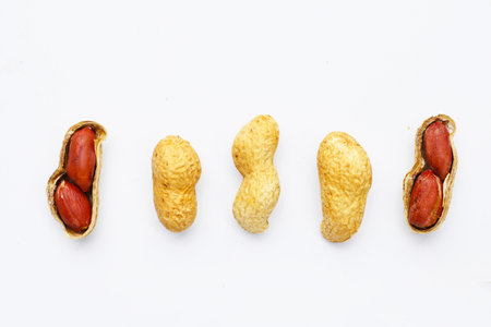 Roasted peanuts in shell on white background.