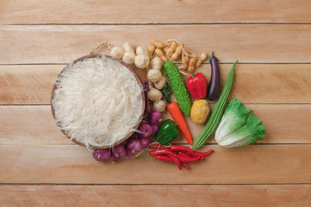 Vegetable in basket , potato , onion , garlic , pepper , carrot , peanut.