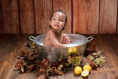 the boy take a bath with lemon.の写真素材