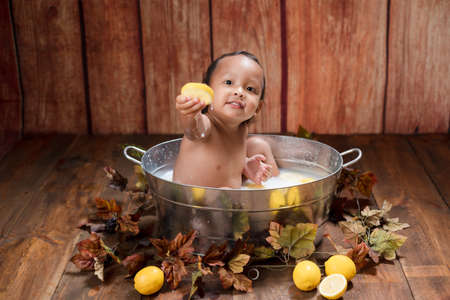 the boy take a bath with lemon.の写真素材