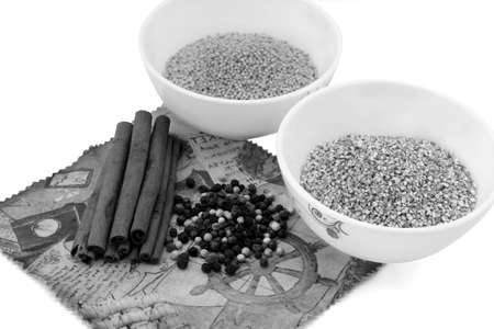 Cereals in plates, cinnamon, spices, mix the peppers on a napkin isolated on white black and whiteの写真素材