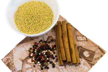 Cereals in plates, cinnamon, spices, mix the peppers on a napkin isolated on whiteの写真素材