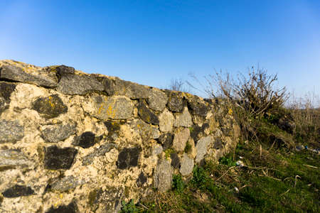 Old stone fence and blue skyの写真素材