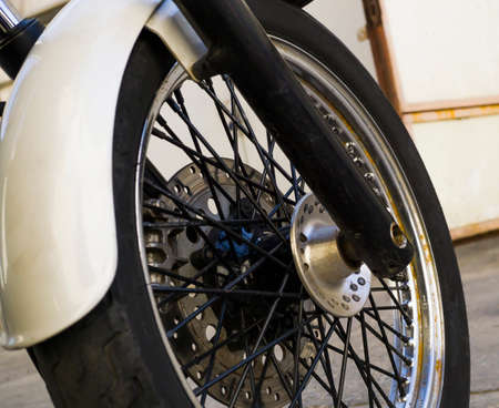 Chrome wheel of white motorcycle background