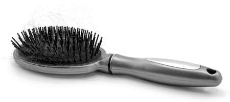 Hairbrush with hair loss black and white isolated on white