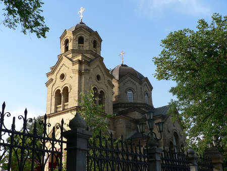 Old christian church on background of gothic fence