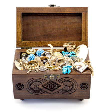 Opened ash wood carved casket handmade with jewelry isolated on whiteの写真素材