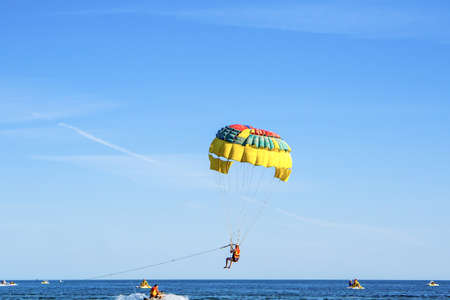 Man sportsman windsurfer flying on parachuteの写真素材