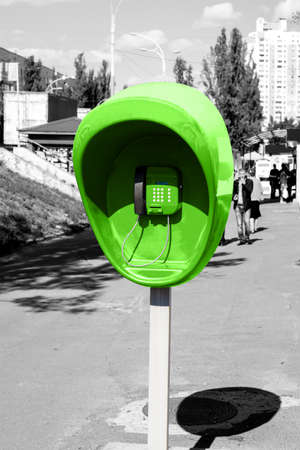 Pillar with the green public telephone set on city street black and white styledの写真素材
