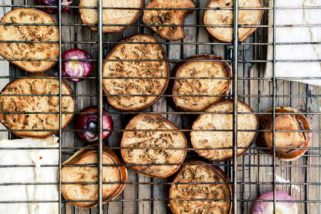 Contrast grill grid with fried zucchini, violet onion and pita bread with cheeseの写真素材