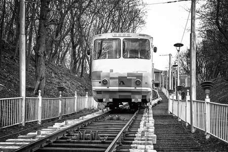 Kiev, Ukraine - March 8, 2016: White funicular train coming down with passengers black and white HDR effectのeditorial素材