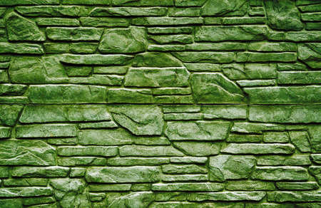 Green stone brick wall detailed contrast texture backgroundの写真素材