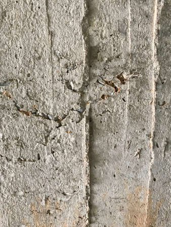 An old Rough floor is made from cement, concrete and sand. It has a hard , dirty and damage  surface. white ruined industrial brick wall with copy spaceの写真素材