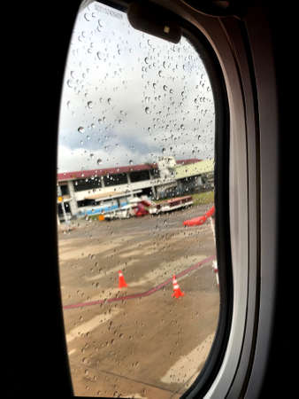 The window seat view is shows clouds and and airport view.