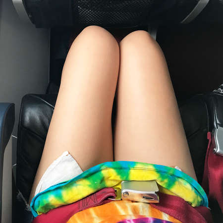 Airplane cabin is all white. All its decorations are necessary stuffs and safety. The gray Tray table for passenger in plane.の写真素材