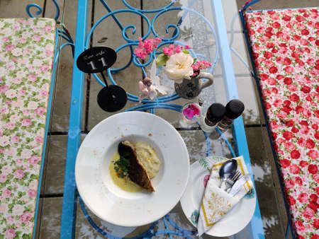 Restaurant table with a cup of coffee and a piece of cake