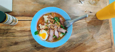 small flat rice noodles with fish balls and shrimp balls in pink soup, Yen Ta Four or Yen Ta Fo -...