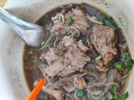 small flat rice noodles with fish balls and shrimp balls in pink soup, Yen Ta Four or Yen Ta Fo -...
