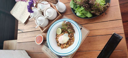 Top view of fried rice with egg on wooden table in cafe.の写真素材