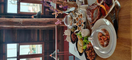 Wedding table decorated with cutlery, candles, glasses and crockery