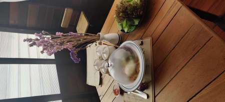 top view of coffee cup and pot on wooden table in coffee shop