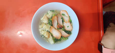small flat rice noodles with fish balls and shrimp balls in pink soup, Yen Ta Four or Yen Ta Fo -...